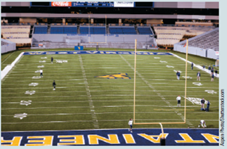 SHOULD COLLEGE ATHLETES BE PAID?  Applicable Concept: monopsony    It was perfect football weather on a beautiful autumn Saturday at Nebraska State's stadium. There was a hush in the crowd of 80,000 as the clock showed 5 seconds left in the game and the scoreboard read Home 26 Visitor 30. The Screaming Eagles were playing the Fighting Irish, and the season was on the line. With time running out, the Eagles All-American quarterback Joe Wyoming launched a desperation pass from his 45-yard line. The pass hit the extended fingers of a wide receiver who leaped over three defenders at the Irish 25-yard line and then ran into the end zone all alone. The home crowd roared with joy after staring defeat in the face. So the season had been in the hands of Joe Wyoming, who received a full scholarship that cost the university more than $40,000 over four years. Because Joe led the Eagles to victory over Notre Dame, the team played in the Sugar Bowl, which paid Nebraska State $5 million for the appearance. In addition, the next year's ticket sales, alumni contributions, and trademark licensing boosted revenues $10 million, while applications for admission to the university increased sharply. Economist John Leonard argued that college athletes are clearly underpaid because players cannot be paid salaries under National Collegiate Athletic Association (NCAA) rules. His study estimated that a star college football player who is named to an All-American team generates a marginal revenue product of $100,000 per year for the university. Yet that athlete is paid only a $10,000 scholarship per year. In Chapter 10, a cartel was explained as a group of firms that use a collusive agreement to act as a monopoly. NCA A regulations serve as a collusive agreement among colleges and universities to act as a monopsony and hire the services of college-bound athletes. Just like an output or sellers' cartel, such as the Organization of Petroleum Exporting Countries (OPEC), the NCAA must enforce the rules against cheaters. Because this agreement holds players' wages far below their marginal revenue product, the gap creates an incentive for schools to offer illegal inducements of cars, money, clothes, and trips to attract good players. Such cheating benefits the college athletes whose wages are raised closer to their marginal revenue products. A school that is not caught benefits by recruiting better players, achieving athletic success, and receiving greater sports revenue. Schools that follow the rules must depend on the NCAA to punish cheaters by taking away TV appearances, tournament play, bowl invitations, and scholarships.    In January of 2015, the NCAA's power five conferences passed legislation that allows universities to provide stipends to cover the cost of attendance. The exact monetary value will vary by school and other conferences are implementing payments to athletes in addition to scholarships. Do you favor paying college athletes salaries determined by a competitive labor market rather than by an NCAA agreement? Explain.