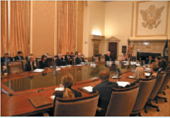 HOW DOES THE FOMC REALLY WORK? Applicable Concept: monetary policy   The Federal Open Market Committee (FOMC), which is the Fed's most powerful monetary policymaking group, meets eight times a year at the Federal Reserve in Washington, D.C. Often it seems that the whole world is watching for the results. Before the meeting, board members are given three books prepared by the Fed's staff. The Green Book forecasts aggregate demand and various prices based on a variety of equations and the assumptions that monetary policy does or does not change. The Blue Book might discuss as many as three monetary policy options, the rationale for each option, and the impact of each option on the economy. There is also a Beige Book, published eight times per year, that gathers anecdotal information on current economic conditions obtained from interviews with key businesspersons, economists, bankers, and other sources. The meeting begins at precisely 9 a.m. with a discussion of foreign currency operations and domestic open market operations illustrated with colorful graphics. Next, the staff presents their analysis of recent developments and forecasts for the economy laid out in the Green Book. Then each board member around the impressive 27-foot oval mahogany table expresses his or her views about the analyses, except for the chair, who may choose not to participate in this round. Now it's coffee time and everyone relaxes beneath a 23-foot ceiling with a 1,000-pound chandelier.   After the coffee break, the staff discusses each policy option from the Blue Book without recommending a particular option. Generally, three options are presented. Option A is always a decline in interest rates, Option B is always no change in interest rates, and Option C is always an increase. After the staff presentation, board members politely discuss the policy options, but with an important difference. In this policy round, the chair goes first. He or she leads the discussion and advocates a policy decision. After other board members express their views, the chair summarizes the consensus and reads a draft of the Directive to be voted on. The Directive gives instructions to the Fed's staff on how to conduct open market operations until the next FOMC meeting. For example, the New York Fed's trading desk may be instructed to increase the money supply in the range of 1 to 5 percent and lower interest rates by buying 90-day U.S. Treasury bills. After discussion, board members vote on the Directive, with the chair voting first and the decision going to the majority. The chair is always expected to be on the winning side. The Directive is sent to the New York Fed's trading desk, and soon about four dozen bond dealers receive the Fed's call. If there is a change in policy, it will be announced at 2:15 that afternoon. The Fed communicates its changes in monetary policy by announcing changes in its targets for the federal funds rate. Recall that the Fed does not set this interest rate, but it can influence the rate through open market operations. If the Fed buys bonds, the supply of excess reserves in the banking system increases, and the rate falls. If the Fed sells bonds, the supply of excess reserves in the banking system decreases, and the rate increases. As a result, interest rates in general are influenced. The next chapter explains in more detail the link between changes in the interest rate and changes in other key macro measures. Between 2001 and 2003, for example, the Fed cut the federal funds rate target 13 times to support economic recovery. Then from 2004 to 2006, the Fed became concerned about inflation and increased the federal funds rate 17 times. When measuring inflation, the Fed pays closest attention to the core CPI-the CPI excluding food and fuel because it is less volatile than the total CPI inflation rate. In 2007, the Fed changed its focus again because it became concerned that a housing slump and credit crunch would slow the economy, and it cut this key rate for the first time in four years. Beginning in 2008, the Fed followed a policy called quantitative easing (QE) that used a sharp rise in purchases of Treasury and mortgage-backed securities to continuously increase the money supply and lower interest rates. In fact, the Fed continued cutting the federal funds rate until it reached a record low of almost zero in 2011. The annual rate for 2014 was also close to zero. What happened at the last FOMC meeting? Visit http://www.federalreserve.gov/fomc/default.htm.