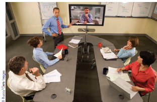 Case Study: The Electronic Cottage How has the development of personal computer hardware and software reversed some of the trends brought on by the Industrial Revolution? Reference Case Study: The Information Economy  The Electronic Cottage The Industrial Revolution shifted production from rural cottages to urban factories. But the Information Revolution spawned by the microchip and the Internet has decentralized the acquisition, analysis, and transmission of information. These days, someone who claims to work at a home office is not necessarily referring to corporate headquarters but to a spare bedroom. According to a recent survey, the number of telecommuters, or remote workers, has more than doubled in the last decade. Pushing the trend are worsening traffic, higher gas prices, wider access to broadband, growing self-employment resulting from layoffs during the recession of 2007-2009, and even the threat of terrorism. The average commute is 23 miles, and eliminating that can save about $1,000 a year in gas and can avoid putting more than 6,000 pounds of carbon dioxide into the atmosphere. What's more, it often makes sense to try a new business at home before moving to a separate, more costly, location. Most small businesses are home-based, at least at the start. From home, people can write a document with coworkers scattered throughout the world, then discuss the project online in real time or have a videoconference on Skype (McDonald's saves millions in travel costs by videoconferencing). Software allows thousands of employees to share electronic files. A 2010 survey found the majority of those who use computers for most of their work believe they could work at home. When Accenture moved headquarters from Boston to a suburb, the company replaced 120 tons of paper records with an online database accessible anytime from anywhere in the world. To support those who work at home, an entire industry has sprung up, with magazines, newsletters, Web sites, and national conferences. In fact, an office need not even be in a specific place. Some people now work in virtual offices, which have no permanent locations. With iPhones, BlackBerries, or other links, remote workers, can conduct business on the road-literally, deals on wheels. Chip technology is decentralizing production, shifting work from a central office either back to the household or to no place in particular. More generally, the Internet has reduced transaction costs, whether it's a market report authored jointly by researchers from around the world or a new computer system assembled from parts ordered over the Internet. Easier communication has even increased contact among distant research scholars. For example, economists living in distant cities are four times more likely to collaborate now than they were two decades ago.   