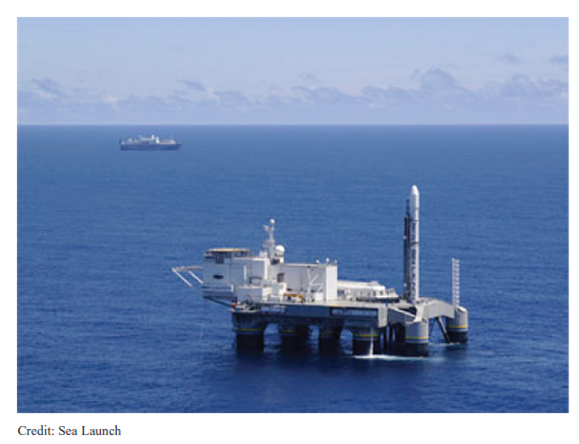 A Sea Launch Recovery  CIRCA 2008  Sea Launch engineers say the three-week round-trip journey across the Pacific Ocean is the most rewarding part of their jobs. The cruise is the culmination of nearly two months of work preparing the rocket, payload, and launch teams for the mission. Prior to operations at Home Port, about 18 months goes into the planning, flight design, and logistics. It's really nice to know most of the reviews are over and we're finally ready to launch, said Bill Rujevcan, mission director for the company's next flight. More than 300 people take the trip to the company's equatorial launch site about 1,400 miles south of Hawaii. The crew includes workers from several nations, including: Ukraine, Russia, Norway, the Philippines, and the United States. Ukraine-based Yuzhnoye and Yuzhmash build the Zenit 3SL rocket's first and second stages, while Energia of Russia manufactures the Block DM-SL upper stage for the rocket. Norwegian ship officers manage marine operations, and Filipino deckhands work on both the Sea Launch Commander and the Odyssey launch platform. U.S. employees from the Boeing Co. fill management roles and provide the flight design, payload fairing, and satellite adapter. Astrotech, a contractor, oversees processing of customer payloads inside a clean room at the company's Payload Processing Facility at Home Port in Long Beach, California. After 27 missions in nine years of business, Sea Launch is thriving in the do-or-die commercial launch industry. The company's Zenit 3SL rocket has suffered three setbacks in that time. Two were total failures. The rocket's success rate places it among the top tier of heavy-lift launchers on the commercial market, and the company's launch backlog seems to confirm that. Sea Launch is already booking payloads for launch in the future. Next year is sold out, according to company officials. Sea Launch Home Port is a decommissioned U.S. Navy facility on the tip of a manmade peninsula at the Port of Long Beach. The Sea Launch buildings are all left over from the Navy except for the Payload Processing Facility, which the company built in the late 1990s. The company's pier is home to two one-of-a-kind vessels-the Sea Launch Commander and the Odyssey launch platform. The Sea Launch Commander carries about 240 people, ranging from rocket technicians and corporate leaders to chefs and helicopter pilots. The Commander houses a state-of-the-art launch control center divided between two sections designed for Ukrainian and Russian engineers and American engineers and managers. The cavernous rocket assembly and checkout hall is located on the command ship's lower deck and stretches nearly the entire length of the vessel. The facility is capable of supporting two simultaneous launch campaigns using staging and integration compartments and a fueling cell. Giant cranes inside the high bays lift rocket stages, which sits on Russian-gauge rails on the floor integration room floor. The rocket's ground support equipment inside the Sea Launch Commander is virtually identical to hardware used for Zenit launches at the Baikonur Cosmodrome in Kazakhstan, according to Sea Launch officials. The Sea Launch Commander was specially constructed for Sea Launch at a Scotland shipyard by the maritime unit of Kvaerner, then a leading Norwegian industrial company. Measuring 656 feet long and 105 feet wide, the command ship was outfitted with more than 600 tons of rocket support equipment in Russia before sailing to Long Beach in 1998. The massive ship's crew quarters are home to Sea Launch's international employees during their stay in the United States. The Sea Launch Commander and the Odyssey platform are seen here docked at Home Port.     As Ukrainian and Russian engineers complete work to ready the Zenit rocket, technicians inside Sea Launch's Payload Processing Facility are busy preparing the booster's satellite payload down the road from the docked vessels. When both groups are ready, the spacecraft is transported about 1,000 feet and loaded into the Sea Launch Commander's final assembly hall on the roll-on, roll-off vessel. Already enclosed in the payload fairing, the satellite is attached to the Zenit-3SL's upper stage to complete the rocket's construction. EchoStar 11, the payload for Sea Launch's mission this month, was rolled from the clean room to the command ship hangar June 25. The 12,150-pound satellite was bolted to the Block DM-SL upper stage a day later. The rocket was next moved to the Odyssey Launch Platform. The launcher, which weighs about 100,000 pounds without propellant, is transferred in a high- precision operation more 200 feet above the waters of Long Beach Harbor. The Sea Launch Commander first pulls in front of Odyssey and the rocket is rolled out of the integration hall. The rocket is then hoisted into Odyssey's hangar, where it stays during the transit from Long Beach to the launch site. Sea Launch then lifts the 200-foot-tall rocket upright on its launch pad for a final series of tests to make sure all systems are ready to set sail for the equator. That's our last big test before we leave, Rujevcan said. Odyssey, the slower of the company's two ships, usually leaves Long Beach a few days before the Sea Launch Commander. The launch platform left port for the EchoStar 11 campaign last week. With a top speed of about 12 knots, Odyssey's crew of 70 sailors and engineers serve as caretakers of the Zenit rocket during the 2,882-mile transit to the launch site along the equator at 154 degrees west longitude. Odyssey is a converted North Sea oil drilling platform built in Japan in 1983. Kvaerner's maritime division modified the vessel between 1995 and 1997 to support rocket launches, according to Sea Launch. The changes included adding two extra vertical support columns, effectively extending the length of the platform to 436 feet. The deck extension was needed to make room for the Zenit launch pad, an immense hole in Odyssey's deck with a gas diffuser directly beneath it, said Paula Korn, Sea Launch spokesperson. Workers replaced more than 20 miles of wiring on Odyssey after Sea Launch suffered a failure on the launch pad during a liftoff last year. The platform underwent a slate of repairs, including the replacement of a destroyed gas deflector and the repainting of the ship, Korn said. The Sea Launch Commander pulled out of port this weekend to begin its trek to the equatorial Pacific. The ship will rendezvous with Odyssey at sea later this week. Officials keep busy during the trip by completing a handful of final prelaunch reviews, two countdown rehearsals and several other meetings, Rujevcan said. The ships also offer a number of recreational activities for the launch team. The Sea Launch Commander carries basketball and volleyball courts, a swimming pool, and a movie theater, not to mention opportunities to play pool, foosball and air hockey. Crews also enjoy access to DirecTV programming and XM Satellite Radio, two regular customers for Sea Launch. The Sea Launch Commander is furnished with a full-service cafeteria and bar, but the booze stops flowing soon after the ships arrive at the launch site. Odyssey's ballast tanks are filled with seawater to submerge the platform's pontoons to a depth of about 65 feet to help keep the vessel stable. The command ship pulls alongside Odyssey and technicians move between the vessels using a 115-foot-long link bridge. The team begins the launch countdown three days prior to liftoff. The Sea Launch Commander sails three-and-a-half miles away from Odyssey a day before launch. A helicopter transfers final personnel and equipment between the vessels. The Zenit 3SL rocket is rolled out of its hangar and erected on the pad about 27 hours before the scheduled launch. Pneumatic pistons power the erector during the 10-minute lifting operation, and technicians torque four hold-down bolts to firmly attach the rocket to the launch pad. The bolts automatically retract from the booster at liftoff. The countdown enters an automated sequence five hours before launch, and the team serves as watchdogs to ensure no preset parameters are breached. The final workers are evacuated from Odyssey about three hours prior to launch. During the final countdown, Odyssey's marine crew occupies a remote control station on the bridge of the Sea Launch Commander. The consoles give the marine officers full control of the launch platform three-and-a-half miles away. Fueling of the Zenit 3SL's three stages with kerosene and liquid oxygen begins two hours and 40 minutes before liftoff. Fuel and oxidizer tanks aboard Odyssey hold enough propellant for three launch attempts, according to Rujevcan. Managers hold their final poll 36 minutes before launch, and the rocket's umbilical arm detaches from the rocket at the 17-minute point. The Zenit's automated sequence reaches a last milestone with one minute to go. At that point, we are committed to launch unless the sequence tells us to stop, Rujevcan said. Now on his 18th mission to the equator, Rujevcan is one of three certified Sea Launch mission directors. The mission director is the final authority on whether the launch occurs. I am the ultimate go guy, he said. Rujevcan oversees a team of about 50 engineers inside the Launch Control Center. The launch team typically conducts three launch rehearsals during each campaign to hone their skills. The launch team monitors the rocket, weather, ship systems, and ground stations to ensure they are all ready for launch. Notices of the launch are issued for vessels traveling in the area to keep at least 25 miles from Odyssey during the final countdown. Sea Launch helicopters and ship-based radar. Officials closely watch Odyssey's exact location during the final moments before launch. Managers allow a tolerance of two kilometers, or about 1.2 miles, from the standard launch site at the intersection of the equator and 154 degrees west longitude. Powerful underwater azimuth thrusters hold Odyssey's heading at launch time. The platform must be within one degree of the expected orientation for launch. A Sea Launch campaign in November was plagued by persistent strong ocean currents and high winds. The underwater thrusters were not enough to match the unruly conditions, and the platform constantly drifted out of position. Officials eventually ordered the ships to return to California after more than two weeks on station at the mid-Pacific launch site. Engineers have since installed extra generators on Odyssey to increase the amount of time the vessel can stay at sea. The unusual experience with ocean currents is an example of how Sea Launch continues to encounter challenges and learn from experience, Korn said. Rujevcan agreed. After 27 missions, you just see a little bit of everything, Rujevcan said. It's never really routine to the point of complacency. CIRCA 2009, HOW FAST THINGS CAN CHANGE!  Sea Launch's bankruptcy filing this week was brought on by recurring financial losses, partially stemming from a 2007 rocket failure that helped set off a cascading series of delays and customer defections, according to court records. A file image shows a Zenit rocket on the Odyssey floating pad ready for flight and the Commander ship overseeing the countdown nearby.     The launch services provider and five affiliated businesses filed for Chapter 11 Bankruptcy protection in a Delaware court. In the filing, the company said it is unable to repay debt or secure new financing, making bankruptcy reorganization the best avenue to keep the company afloat. Officials say they intend to continue normal business operations, including the pursuit of new launch contracts to bring in new revenue. Whether satellite operators will sign with a company in bankruptcy remains to be seen, but Sea Launch leaders attempted to ease their concerns. We want to assure our customers, employees, suppliers and partners that Sea Launch intends to continue to operate after the filing, said Kjell Karlsen, president and general manager of Sea Launch. Chapter 11 reorganization provides an opportunity for us to continue operations and focus on building our future plans. We are grateful for the continued support of our customers and partners while we focus on reorganizing for the future. Two more launches had been planned for 2009. Sea Launch has contracts for 10 launches through 2012, officials said. Sea Launch reported assets between $100 million and $500 million and estimated debt of almost $2 billion. The company will explore the potential sale of one or more of its business units during the bankruptcy proceedings, officials said. The company has long been on shaky financial ground and has struggled to recognize the success envisioned when it was formed in 1995, according to the filing. Officials blamed the weak commercial launch industry, skyrocketing hardware costs, the credit crunch, and intense competition from other launch providers for being unable to stabilize their business or meet their financial targets, according to a declaration by Brett Carman, Sea Launch's vice president and chief financial officer. Carman cited Sea Launch's government-backed competitors in Europe and Russia, which snatched commercial satellites left stranded on the ground following a dramatic launch failure in January 2007. That accident destroyed the Zenit 3SL rocket and a Dutch telecommunications satellite before they even left the launch pad. The massive explosion also damaged the company's Odyssey launch platform and grounded the Zenit rocket for nearly one year. Sea Launch has completed nine launches since returning to flight in January 2008, including six missions staged from sea and three flights under the company's Land Launch subsidiary. But the delays caused several customers to move their launches to Arianespace and International Launch Services, Sea Launch's primary competitors, to ensure their satellites could be sent into orbit on time. Arianespace offers dual-payload launches on its Ariane 5 rocket, while ILS uses the venerable Russian Proton booster launched from the Baikonur Cosmodrome in Kazakhstan. The impact from the failure was largely focused on lost schedule time, said Paula Korn, a Sea Launch spokesperson. While we were able to reschedule some of our customers' missions, a few missions were reassigned or moved off the Sea Launch system to other launch providers. One customer, Hughes Network Systems, moved their satellite to an Ariane 5 rocket a month after the mishap. Hughes also filed a claim for a $44.4 million reimbursement for advance payments the satellite operator had already paid Sea Launch. After Sea Launch contested the claim, an arbitration decision earlier this year ruled in favor of Hughes, saying the launch provider had to pay the advance payments plus interest, an amount totaling $52.3 million. A standstill agreement brokered in March between Sea Launch and Hughes later expired, and Hughes filed another petition earlier this month to recoup the money. The parties could not reach a payment agreement by the June 22 deadline, the same day Sea Launch filed its Chapter 11 petition. In a written response to questions, Korn said delays in the delivery of crucial rocket equipment caused further delays, exacerbating Sea Launch's financial problems. The missed delivery milestones were blamed partly on the world's financial crisis. The late deliveries also made it more difficult for Sea Launch to meet its customers' schedule requirements, causing more payloads to jump to other rockets. Sea Launch has lost three more payloads so far this year to the Proton rocket, according to an ILS statement last week. Carman's declaration also detailed debts owed Sea Launch's investors and creditors, including $119 million in cost overruns still unpaid from the company's early development work in the late 1990s. Sea Launch is owned by corporate shareholders in the United States, Russia, Norway, and Ukraine. Boeing Co. holds a 40 percent stake in the partnership, providing support services and hardware for the Zenit rocket's payload unit. Sea Launch owes Boeing nearly $1 billion in loans, trade debt, and partner liabilities, according to the bankruptcy filing. Russia-based Energia, which holds a 25 percent interest, builds the rocket's Block DM-SL upper stage and supports launch vehicle integration and mission operations. Aker, a Norwegian shipbuilder, constructed the company's command ship and launch platform and owns 20 percent of the company. Ukrainian rocket manufacturers Yuzhnye and Yuzhnoye control a 15 percent share of Sea Launch. Sea Launch owes more than $1.5 billion to its investors, according to figures provided in court documents. The rest of its debt is in bank loans. The company stopped paying its suppliers as its financial health slipped, according to Monday's filing. Boeing and the other Sea Launch partners support Sea Launch's effort to explore restructuring alternatives through an orderly bankruptcy court process, Boeing said in a written statement. Sea Launch and its Land Launch division have carried out 33 missions since 1999. Thirty of those launches were deemed total successes. We are hoping to get back on our feet and move forward, doing what we do best, putting our customers' satellites in orbit, Korn said. CIRCA 2010  Launch services provider Sea Launch Co. is in advanced negotiations with two potential strategic investors and expects to emerge from Chapter 11 bankruptcy proceedings by midyear and to return to operations in 2011, Sea Launch President Kjell Karlsen said. Karlsen declined to name one of the investors. The other is Space Launch Services, created by Excalibur Almaz, a company founded to launch astronauts into orbit to stay at a space station based on existing Russian hardware. The company also has been looking at making the Russian-Ukrainian Zenit launch system capable of launching astronauts. Sea Launch uses the Zenit rocket to launch satellites. It's a tough market, that's for certain, and there aren't a lot of Elon Musks around, Karlsen said, referring to the Internet entrepreneur who has devoted much of his fortune to starting the rocket-launch company Space Exploration Technologies. Space Launch Services has been providing Sea Launch with sufficient cash to carry it through Chapter 11 but has not yet confirmed whether it has the will or the resources to operate Sea Launch as a business. Space Launch Services officials, attending the March 3 World Space Risk Forum in Dubai, said one option they are considering is whether to relocate the Sea Launch ocean-launch platform closer to U.S. territory. A launch from U.S. territorial waters would have the dual advantage of reducing the time and expense of positioning the floating launch platform in the Pacific Ocean on the equator, and increasing the possibility that Sea Launch could qualify as a U.S. launch system and thereby compete for U.S. civil government launch contracts. In an interview, Karlsen said that post-Chapter 11, a Sea Launch operation freed from its debt service could be operated for about $50 million per year. The biggest cost is the Sea Launch Commander control ship, which accompanies the Odyssey launch platform to and from the launch site. Sea Launch lost money every year since its first flight in 1999 and accumulated some $1.4 billion in losses before filing for protection under Chapter 11 of the U.S. bankruptcy code in mid-2009. Karlsen said Sea Launch has three contracts-one from Intelsat of Washington and Luxembourg, and two from Paris-based Eutelsat-on its books. Refurbishing the launch platform and the command ship after months of inactivity would not be expensive, he said, and the commercial launch market-in the form of satellite fleet operator support for Sea Launch-appears to want Sea Launch back in business. Sea Launch's investors, led by Boeing, which had a 40 percent equity stake in the company, are now involved in the Chapter 11 bankruptcy court proceedings in Delaware, their lawyers hoping to salvage at least part of these companies' investment. Boeing also is seeking reimbursement from Sea Launch's Russian and Ukrainian partners for Boeing loans made on behalf of the company. Karlsen said that when it comes to a decision point, Boeing, Aker of Norway, and RSC Energia of Russia and Yuzhnoye of Ukraine will agree it is in their interests to have Sea Launch return to flight, even if it means abandoning hope of recouping their investment. The alternative-a Chapter 7 liquidation of Sea Launch's assets-would fetch between $100 million and $130 million, Karlsen said. 2010, INDIA UPS THE ANTE  India plans to cut satellite launch cost by half with the heavy-lift rocket that it is developing, a senior space department official said. The country is also aiming a two-to-three fold increase in the number of spacecraft launches from this year, Chairman of Indian Space Research Organisation K Radhakrishnan said. GSLV-Mk III that ISRO is developing now would bring down the satellite launch cost at least by half, at present, the launch cost is pegged at around USD 20,000 per kilogram, he said. GSLV-Mk III, which would have the capability to launch satellites of four tonne class, nearly twice the mass that ISRO can currently carry to space, is expected to be operational in next two-three years. Delivering the inaugural lecture of IIScAA (Indian Institute of Science Alumni Association), he said India currently has 211 communication transponders, including 195 operational. Go to www.space.com/missionlaunches/2010-launch-log.html and review the history of space launches toward forecasting demand for Sea Launch's services for the next five years.