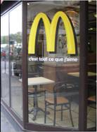 THE GLOBALIZATION OF THE MOST UBIQUITOUS OF AMERICAN CUISINES-THE HAMBURGER  From the Maharaja Mac in India to the Prosperity Burger prepared especially for the Chinese New Year celebrations, McDonald's has built a global fast-food empire under its golden arches. Only 31 percent of McDonald's revenue now comes from sales in the United States, and most of its international growth has come from the surging economies of Brazil, Russia, China, and India. A pioneer in overseas franchising, McDonald's has spared no effort in its attempts to penetrate foreign markets. In China, it plans to open one new outlet daily to meet its immediate goal of 2,000 stores. In Brazil, it created Latin America's first environmentally certified fast-food restaurant. A vast market defined by stark cultural differences, India has required a more modest approach that would allow McDonald's to develop its real estate and supply infrastructure, train its local workforce and management at its famed Hamburger University, and adjust the menu for vegetarian customers. The McAloo Tikki Burger has been a great success, and the company has started opening more McCafe storefronts.     McDonald's France: I am loving it.  But McDonald's growth strategy relies on more than just added locations. In crowded cities, with real estate prices too high to build drive-through restaurants, the company has hired droves of motorbike drivers to bring Big Macs to customers. This nimble delivery approach is now a mainstay in cities from Beijing to Kuwait City. Online ordering will be next, though the challenge will be to reduce the cost of call centers to support this new distribution model. In addition, McDonald's keeps looking for new mobile innovations, such as mobile ordering or payment options, to keep up with consumer demand. Fast-food restaurants enjoy some segment-specific benefits as they pursue such international expansion. Unlike retail brands, such as Walmart or Carrefour, restaurants pose less perceived competitive threats. Local eateries can exist side-by-side with a McDonald's, in a way that a mom-and-pop grocer cannot survive if an international hypermarket moves in next door. But even considering the massive growth in rapidly transitioning economies, Europe still generates the bulk of foreign sales for McDonald's. In France, for example, MacDo restaurants attract crowds that line up outside for a bite of lunch. But lunch might mean something a little different in this case: French McDonald's offer menus that feature Camembert cheese on the burgers, Heineken, and a McBaguette. Once, the secret to McDonald's success was lockstep consistency, the fact that a meal in Memphis tasted the same as it did in Moscow or Madrid. But the novelty of the American hamburger stand has worn off in the new millennium, and with it McDonald's ability to export American culture as its staple commodity. A cheeseburger, fries, and Coke don't register the same level of excitement when the café next door and the bistro down the block are also serving burgers. More and more, the key to McDonald's future appears to be found in the DNA of the places it inhabits. And with it, suddenly the fast-food giant that to many represents the globalization of taste suddenly finds itself in a very unlikely position: as a defender of local cuisine. The kosher burger has been a hit in Israel, and Indian consumers seem to appreciate the opening of McDonald's first vegetarian restaurant. However, most new growth comes from Russia, where the company has 245 locations and controls 70 percent of the booming fast-food business. Even as fast-food competitors face potential market saturation in the United States, Russian demand for quick burgers appears to be insatiable. Driving this Russian appetite has been the growth of a newly affluent middle class, with money to spend to dine out. Infrastructure development in Russia also has been a boon as cities open malls with food courts, highways are constructed with drive-through locations, and specialty suppliers of frozen food and packaging have appeared. In the early years of Russian expansion, few private businesses existed to supply all the ingredients McDonald's needed to produce Big Macs and fries. The company solved the problem by building an enormous food processing plant outside Moscow. But it also worked to cultivate relationships with local Russian vendors and contractors to which it eventually could outsource its supply chain. Today, a grower who began selling cucumbers to McDonald's in 1990 has become the Pickle King of Russia, dominating the processed foods market.     McDonald's is successful in Israel because of its kosher offerings.  Which sociocultural factors have informed McDonald's global expansion