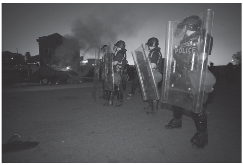 Caught in the War Zone  MIKE GRUNDMANN AND ROGER SOENKSEN James Madison University  War Zone blared the giant headline above photos of fire, vandalism and drunken students being arrested by police in riot gear. This was an out-of-control Springfest, the annual pre-finals block party at James Madison University in Virginia. The Virginia event is but one rite of spring held on college campuses across the nation. Iowa State calls it Veishea and that event has turned ugly more than once over the years. At the University of Colorado's similar event, more than 10,000 people show up to smoke pot. By 2010, on the campus of the University of Virginia, Springfest had ballooned thanks to notices on Facebook that drew students and nonstudents from other states. The 2010 number, estimated to be about 8,000, was about four times larger than previous years according to the Post, and the block party began to get out of control. Two photographers for The Breeze, the twice-weekly student newspaper, had taken hundreds of photos of the event and continued as the crowd grew more unruly, spilling into a nearby neighborhood. According to the Post, President Linwood H. Rose e-mailed the entire 18,500 student campus the following Sunday. Your collective behavior was an embarrassment to your university and a discredit to our reputation, he wrote. No one is opposed to some fun on a beautiful spring weekend, but public drunkenness, destruction of property, and threats to personal safety are unacceptable outcomes. Five days after the melee, the chief local prosecutor, Marsha Garst, was pursuing claims that both attendees and police as well had been assaulted. In trying to find the perpetrators who might have escaped the police dragnet, Garst's office asked The Breeze editor, Katie Thisdell, and a faculty adviser to turn over any unpublished photos so offenders could be identified and arrested. Both refused, on grounds that the paper could not make itself an arm of the law and must remain independent. The next day, Garst, joined by the campus police chief and other law officers, raided the newsroom with a search warrant. It demanded all Springfest photos under threat of confiscating all computers, cameras, cellphones and other devices that could contain the photos. The number of photos seized in this manner was more than 900, according to the Washington Post.  Acting on the advice of the Student Press Law Center (SPLC), Thisdell refused, citing the federal Privacy Protection Act (PPA), which shields newspapers from such seizures until they can be challenged in court. The PPA was passed in 1980 just after the state of California had successfully pursued a newsroom search and seizure over the objection of the editors. Interestingly, this case, too, also sprang from a college campus-Stanford University, where the students had photos of ariot on campus and had refused to turn them over. However, this congressional action did not sway Garst, who stuck to her ultimatum. Thisdell, who considered a newsroom emptied of its tools an unacceptable option, relented and turned over all the photos. Thisdell and her advisers alerted news media in the region, and the story went national, including a Washington Post editorial condemning Garst. The Breeze also provided continuous coverage of its own story, but not using any of the staffers directly involved. The state attorney general, Ken Cuccinelli, at a speaking engagement in town, was asked his opinion of Garst's actions. He supported them. A lawyer provided free by the SPLC finally convinced Garst of the Privacy Protection Act's provisions and persuaded her to surrender the photos to a neutral third party so negotiations over the next step could begin. The lawyer advised Thisdell: You can stand by your principle and refuse to turn over any of the photos, but with a plurality of conservative judges, there was a risk of a court order essentially matching the search warrant. Or you can negotiate with Garst to turn over the few photos that show suspects Garst is after. Thisdell, her advisers and her photographers considered the consequences of both choices. Refusing could mean a newsroom shutdown, public accusations of shielding criminals, and weeks, months or years of court appearances. Compromising could embolden future prosecutors, harm The Breeze 's journalistic reputation and discourage important future sources. Thisdell decided to compromise and ultimately turned over 20 photos. As part of the bargain, The Breeze won a public apology from Garst, who said she regretted frightening the student journalists and would follow the law next time.     Rober Boag, The Breeze      Rober Boag, The Breeze  What are the ethical issues in the paper covering its own story? Can any medium be objective when the story-in whole or in part-is about it?