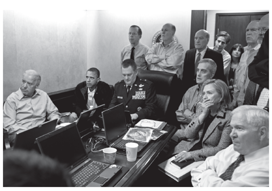 What Would Socrates Have Done? The Disappearance of Hillary Clinton  LEE WILKINS University of Missouri  Photographs are sometimes labeled iconic too soon. But the photograph of President Barack Obama surrounded by his cabinet watching the real-time video of the attack on the compound where Osama bin Laden had been in hiding was labeled iconic before it was 24 hours old. As you look at the picture, notice that the papers in front of Secretary of State Hillary Clinton and others are blurred. The White House, before it released the photograph, distorted the image so that, it said, high-security information would not be revealed through a detailed examination of the photograph itself.     Official White House Photo by Pete Souza  The meaning of the photograph, generally through an analysis of the expressions on people's faces, has been debated. For example, many who viewed the photograph said Clinton was the only person in the room showing shock at the images. Clinton herself has countered that interpretation, saying she was merely covering her nose and mouth to block a sneeze. The photograph itself, as well as the raid on the bin Laden compound, also became of the subject of a political campaign commercial and the subtext for foreign policy discussions in the 2012 presidential election. Numerous print publications and broadcast outlets reproduced the photo. One of those was a Brooklyn-based Hasidic newspaper Der Zeitung, a paper that is written in Yiddish and serves a small segment of the ultra-orthodox Jewish community in that city. In the photograph of the bin Laden raid printed in Der Zeitung, the image of Hillary Clinton and White House staffer Audrey Tomason, director for counterterrorism for the U.S. Security Council, were literally Photoshopped out of the picture. Editors claimed that Secretary Clinton was deleted from the photograph because the paper serves a readership that places a high value on female modesty. Critics countered that Der Zeitung, which translates as  The Time,  has edited out other images of women because the publication itself has an ideological objection to women holding positions of power. Visit these links to read more about this story and see Der Zeitung's controversial photo: http://www.washingtonpost.com/blogs/blogpost/post/hillary-clinton-audrey-tomason-go-missing-insituation-room-photo-in-der-tzitung-newspaper/2011/05/09/AFfJbVYG_blog.html http://www.npr.org/blogs/thetwo-way/2011/05/09/136143892/hasidic-newspaper-removes-clinton-another-woman-from-iconic-photo As you look at the two images, does how Hillary Clinton is dressed support the claim of editing for female modesty?