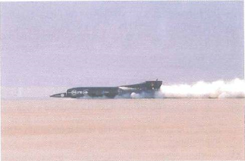 Driving a jet-powered car, Royal Air Force pilot Andy Green broke the sound barrier on land for the first time and achieved a record land speed of more than 763 mi/h in Black Rock Desert, Nevada, on October 15, 1997 (Fig.). (a) What is this speed expressed in m/s (b) How long would it take the jet-powered car to travel the length of a 300-ft football field at this speed ( Hint: v = d/t. )     FIGURE Record run see Exercise.