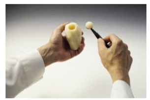 Identify the procedure shown in the picture. -  A)  Cutting parisienne B)  Chopping mirepoix C)  Tournéing D)  Dicing