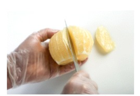 Identify the procedure shown in the picture. -  A)  Tournéing B)  Chopping mirepoix C)  Cutting parisienne D)  Cutting suprêmes
