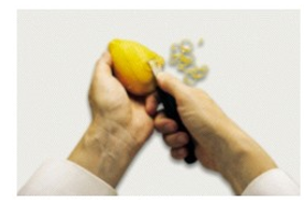 Identify the procedure shown in the picture. -  A)  Zesting B)  Cutting chiffonade C)  Cutting parisienne D)  Cutting suprêmes