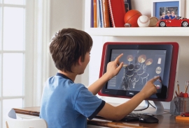<strong> -The boy in the accompanying figure is using a computer with a ____.</strong> A) keyboard screen B) touch screen C) braille screen D) tab screen
