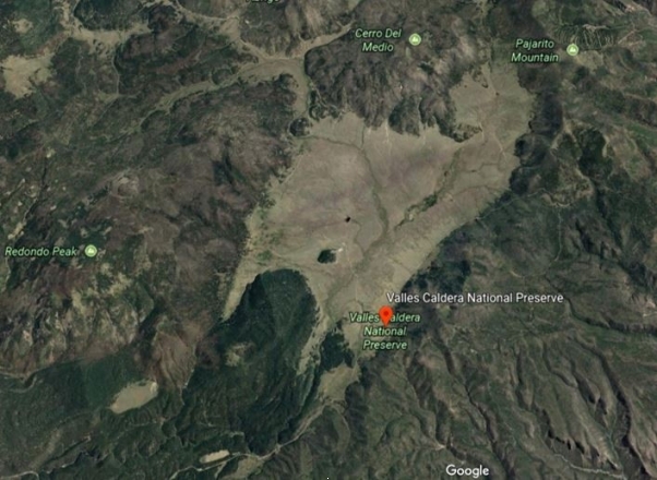   This image of the Valles Caldera in New Mexico shows a landscape in which there is a large flat meadow surrounded by rocky rims of volcanic rock. The meadow is several miles across. Why is this called a caldera? A)  It has volcanic rock. B)  It is a crater. C)  It is several miles across. D)  All of the above are correct. 