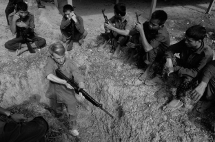 When a civil society prepares for war, this preparation includes production of weapons and the glorification of war. What is this process called?   A)  arming B)  fortification C)  mobilization D)  militarization