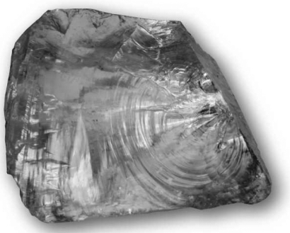 The image below shows a mineral specimen of quartz.What is the term for the smoothly curving,clamshell-shaped surface on the sample below?   A) conchoidal fracture B) facet C) cleavage plane D) striation