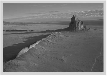 <strong>A volcanic neck,such as that seen at Shiprock,New Mexico (below),is a(n)________. </strong> A)sheet-like intrusion that lies parallel to surrounding layers of sedimentary rock B)cooled layer of lava C)intrusion formed within the magma chamber of a volcano D)sheet-like intrusion that cuts across preexisting layers