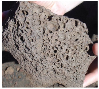The origin of the holes on this rock surface from Hawaii is:   A)  rainfall impact during solidification. B)  microbiological action,that is,microbes decompose organic material which is incorporated into solids. C)  gas that escaped during lava solidification. D)  all of these. E)  unknown,the rock could come from another planet.