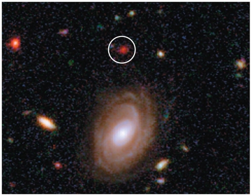   In this picture, we are seeing light from the circled elliptical galaxy (HUDF- JD2) from when the universe was only about 800 million years old. The spiral galaxy below it is much closer. Why does HUDF- JD2 appear a deep red, compared to the whitish color of the nearby spiral? A) Thick dust from active star formation blocks all the blue light, only letting red light escape. B) At such a large distance, all the light emitted by it is very redshifted. C) Even at this young age, the galaxy contains few high mass blue stars. D) A and B E) B and C
