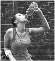 Examine the figure below.   What best explains why the young woman is drinking after her exercise session? A)  Exercise creates body heat, which needs to be eliminated. B)  Cold water cools the body and restores the temperature balance-a process known as homeostasis. C)  The beverage is most likely a sugar-sweetened soft drink; sugar replenishes the energy lost during exercise. D)  Sweating to eliminate excess heat is a source of water loss, which must be replenished if homeostasis is to be maintained.