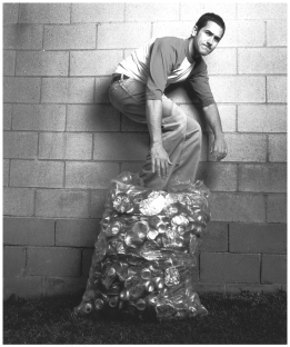 In the photo below, the person is crushing aluminum cans.   What best explains the benefit of the action depicted? A)  Toxic waste aluminum is prevented from reentering the biosphere, where it could further degrade the environment. B)  Aluminum recycling prevents environmental damage by reducing the necessity of mining aluminum ore and saves the energy needed to ship and process that ore. C)  Collecting scrap aluminum permits the continued manufacturing of the weapons necessary for the defense of this country. D)  When deposited in shallow marine habitats, aluminum cans can create artificial reef habitats that are quickly colonized by fish and shellfish.