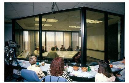   -Consider the Marketing Research Method Photo above. What type of marketing research method is most likely being represented here, with observers behind a one-way mirror watching a discussion among people about topics of interest to marketers? A) individual interview B) questionnaire data C) social network D) information panel E) focus group