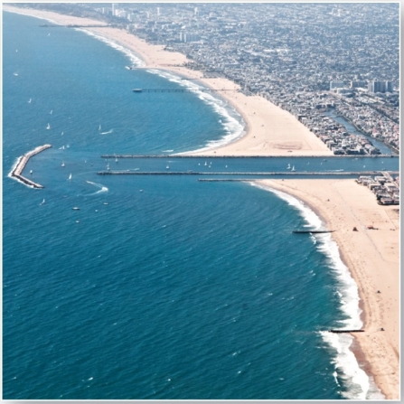   These features block material from entering a harbor. A)  breakwaters B)  groins C)  jetties D)  tombolos