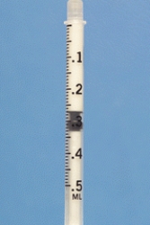 Identify the dosage measured on the syringe.  