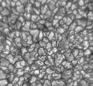 Which of the following is true of the solar surface features seen in the image below?   A)  The patterns are created in the chromosphere. B)  The dark spots have a higher temperature than the light spots. C)  The patterns are created by magnetic field variations. D)  The light spots have blueshifted absorption features.