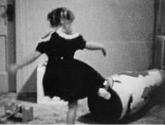 What is shown in this photo?   A) the use of shaping and positive reinforcement to teach a child self-defense skills B) an experimental demonstration of the cause and effect relationship between watching violent behavior in the media behavior in real life C) a demonstration of the phenomenon of “learned helplessness” in children D) the imitation of an adult's aggressive actions that the child saw in a movie