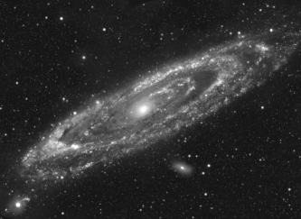 The image below was probably taken in ____________ wavelengths because _______________________.   A)  radio; the disk probably contains many planets with intelligent life, who are beaming out radio and television signals into space B)  infrared; the central regions are bright, and cool stars in the bulges emit a lot of infrared light C)  visible; there is a lot dust in this galaxy that blocks light in a ring about halfway along the disk D)  ultraviolet; the light from hot young stars is mainly found along spiral arms E)  X-ray; the central nucleus is easily seen, and AGN emit a lot of X-rays