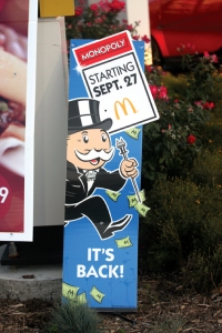   McDonald's Sales Promotion Image -As shown in the McDonald's Sales Promotion Image above,McDonald's partners with Hasbro each year to offer a Monopoly sales promotion that involves customers who purchase selected menu items will receive two tokens that correspond to the properties on the popular game board.If a set of tokens match the color-coded properties,customers will win a cash prize of up to $1 million.Customers may also win  Instant  prizes redeemable for specific food or drink items.What is this popular sales promotion? A) lottery B) contest C) premium D) sweepstakes E) deal
