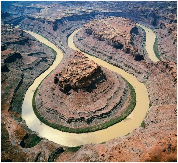    Examine this photograph. Identify the features seen here, and describe in detail the sequence of events which must have occurred in order to produce these features.