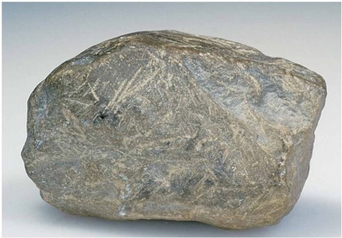   This cobble shows prominent scratches because ________. A) it was tumbled in a stream B) it was scraped against other rocks in a glacier C) it was blasted by wind D) this was its shape when it was mechanically weathered from its source rock