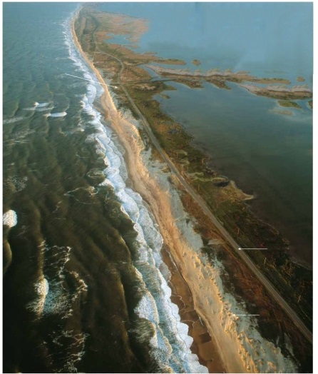 Does this photograph show a tombolo, a barrier island, a sea arch, or a marine terrace? ________