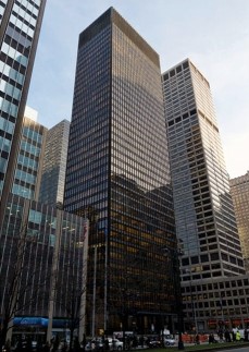 The building on the right within the figure     A) is more modernist, because of its squarish, rectilinear shape. B) is more post-modernist because of its odd angles and shapes. C) is more structuralist because the underlying steel cannot be seen. D) is more Marxist because this building led to worker revolt.
