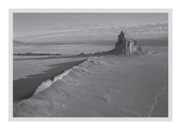 A volcanic neck,such as that seen at Shiprock,New Mexico (below) ,is a(n) ____________.   A) sheet-like intrusion that lies parallel to surrounding layers of sedimentary rock B) cooled layer of lava C) intrusion formed within the magma chamber of a volcano D) sheet-like intrusion that cuts across preexisting layers