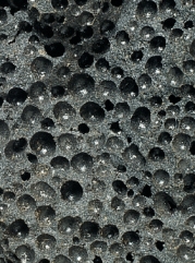 The figure below is an igneous rock with what kind of texture? Hint: Do not be confused by the holes.   A) glassy B) aphanitic C) phaneritic D) porphyritic E) groundmass