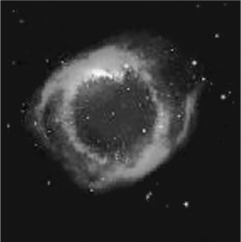What ionizes the gas in a planetary nebula (see the image below) and makes it visible?   A)  X-ray photons emitted by a pulsar B)  Ultraviolet photons emitted by a white dwarf C)  The shock wave from a supernova D)  Hydrogen burning in the nebular gas
