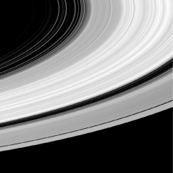 How does the thickness of Saturn's bright ring system compare to its diameter?   A)  It's about 10 times thinner. B)  It's about 1,000 times thinner. C)  It's about 100,000 times thinner. D)  It's about 10 million times thinner.