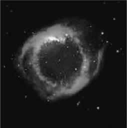 What ionizes the gas in a planetary nebula (see the image below) and makes it visible?   A)  X-ray photons emitted by a pulsar B)  ultraviolet photons emitted by a white dwarf C)  the shock wave from a supernova D)  hydrogen burning in the nebular gas