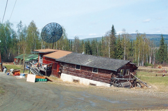 The most likely reason that this building in the tundra environment has a failed foundation is that   A) the permafrost beneath it has thawed. B) running water after a flood has swept it away. C) mass wasting processes have caused the soil to slump. D) a wind storm has detached the building from its foundation.