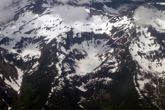 The circular-shaped mass of ice shown in the center of the photograph below is a(n)    A) cirque glacier. B) ice sheet. C) snowfield. D) ice shelf.