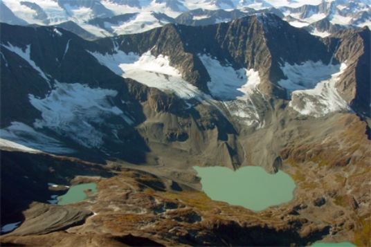 The lakes in the photograph below are all connected by a stream, so they are called   A) cols. B) kames. C) paternoster lakes. D) cirques.