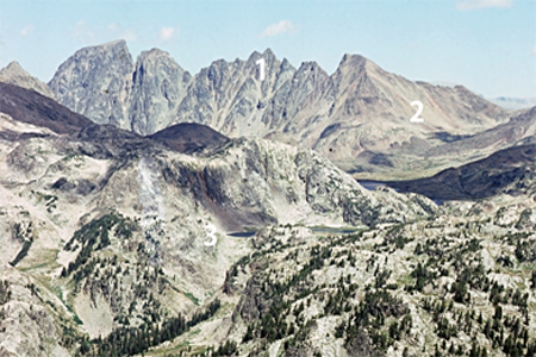 Which numbered feature(s) on this photograph are consistent with the presence of glaciers sometime in the past?   A) 1, an arête B) 2, U-shaped valley C) 3, tarn D) All of these.