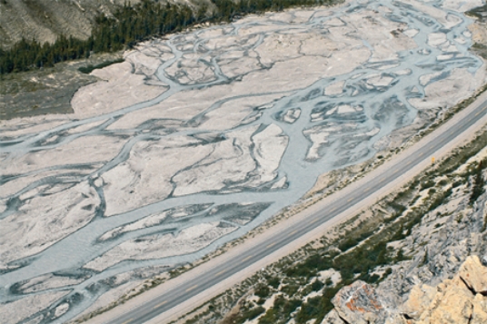 What type of stream is shown in this photograph?   A) meandering stream B) braided stream C) a stream whose main channel has high sinuosity D) an esker