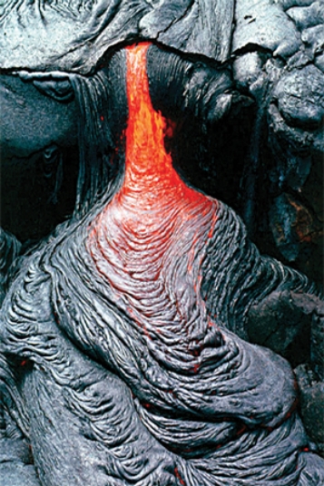 What type of basaltic feature is shown in this photograph?   A) vesicles B) volcanic bomb C) aa lava flow D) pahoehoe lava flow E) pyroclastic flow