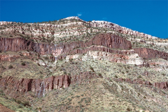 The dark igneous features shown in this photograph are   A) dikes. B) sills. C) volcanic necks. D) batholiths.