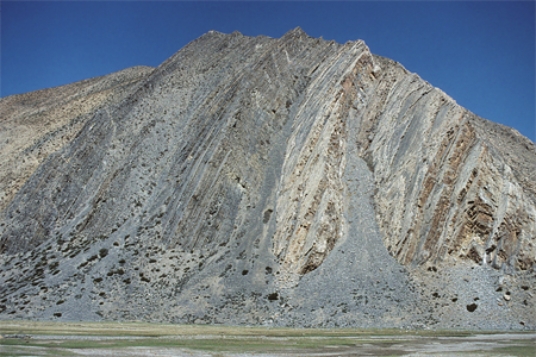What type of deformation is shown in this photograph?   A) displacement B) rotation C) internal strain of the rock D) columnar joints