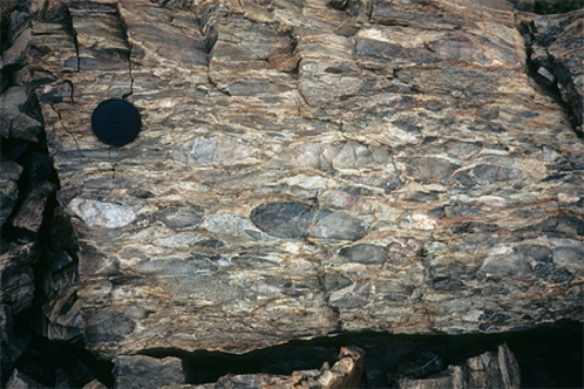 What type of deformation is shown in this photograph?   A) displacement B) rotation C) internal strain of the rock D) columnar joints
