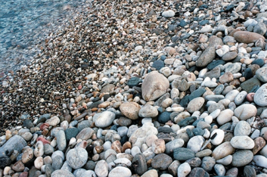 Which of the following surface environments is the most likely site for deposits in this photograph?   A) steep mountain front B) glacier C) sand dunes D) beach