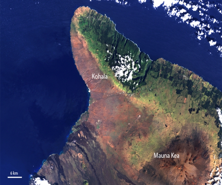 What is the predominant wind direction that results in the rain shadow observed in this picture from one of the Hawaiian Islands?   A) southwest B) southeast C) northwest D) northeast