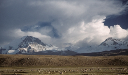 In this image from Tibet, water is expressed in a visible form through   A) water vapor in the atmosphere. B) clouds suspended in the atmosphere. C) ice and snow. D) clouds, ice, and snow. E) All of the answers here.