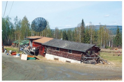 The most likely reason that this building in the tundra environment has a failed foundation is that   A) the permafrost beneath it has thawed. B) running water after a flood has swept it away. C) mass wasting processes have caused the soil to slump. D) a wind storm has detached the building from its foundation.