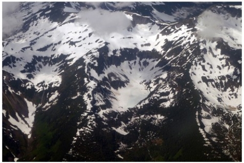 The circular-shaped mass of ice shown in the center of the photograph below is a(n)    A) cirque glacier. B) ice sheet. C) snowfield. D) ice shelf.